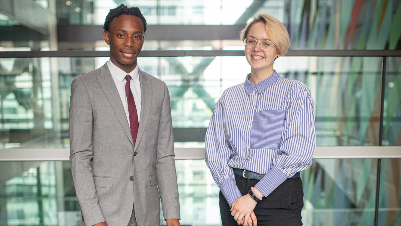 Two students smiling