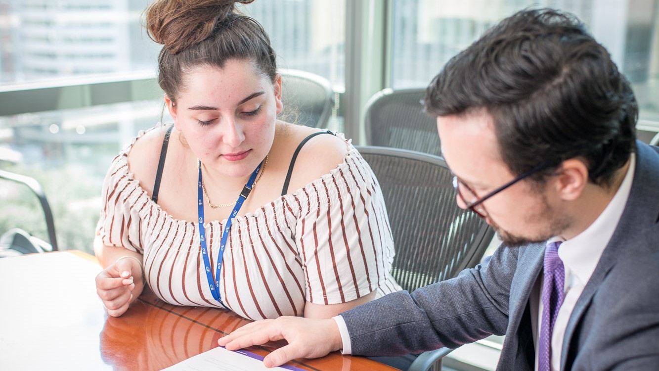 student and mentor sit at desk